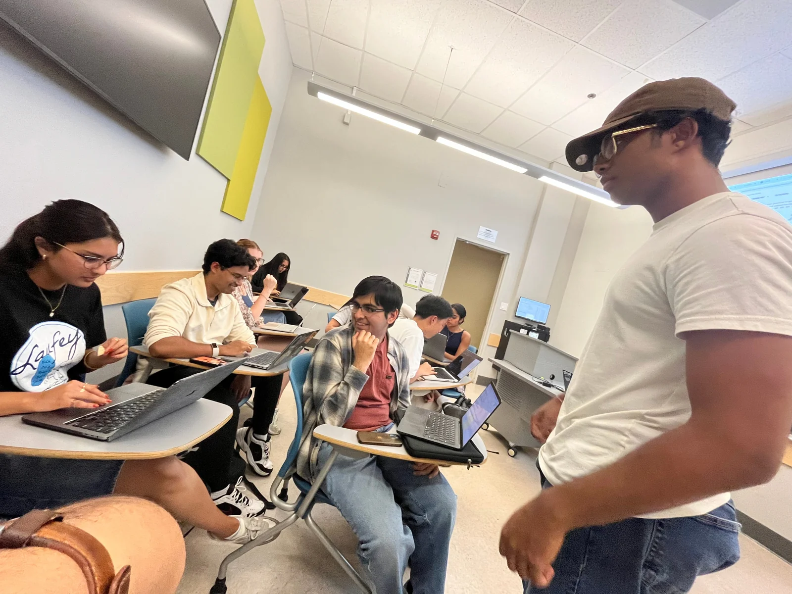 Bootcamp leaders helping students with workshop materials